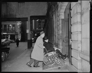 Man pushing Mayor Collins into the building