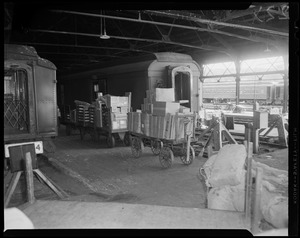 Train cars with loaded carts on platform