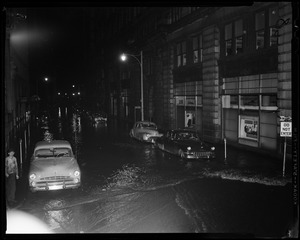 Flooded street with cars parked on either side