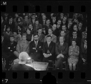 Unidentified speaker addressing an audience from a lectern